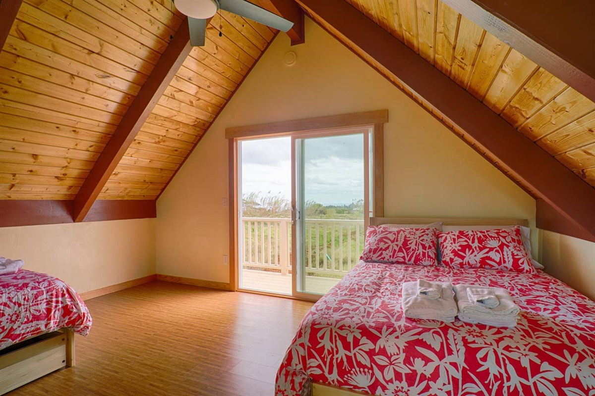 The loft features two double beds sleeping 4. The upstairs lanai overlooks Puna and Hilo Bay, with distant ocean views on clear days. The loft also overlooks the waterfall on the other side.