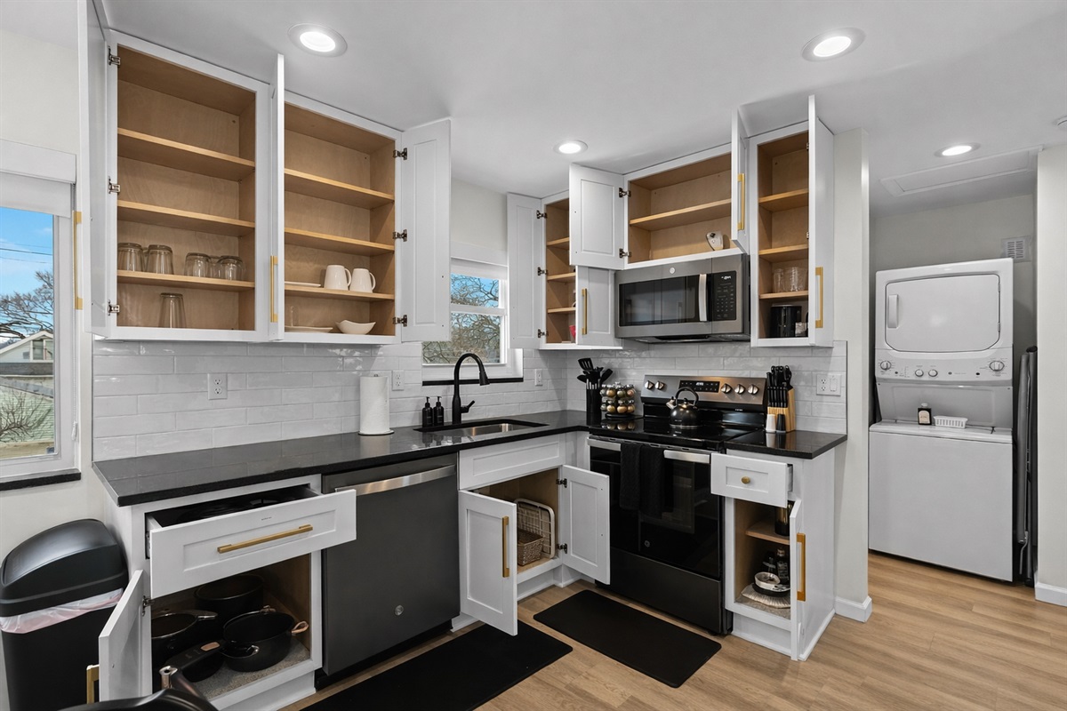 Modern, fully equipped kitchen with ample storage, sleek finishes, and in-unit laundry—perfect for cooking, prepping, and extended stays.