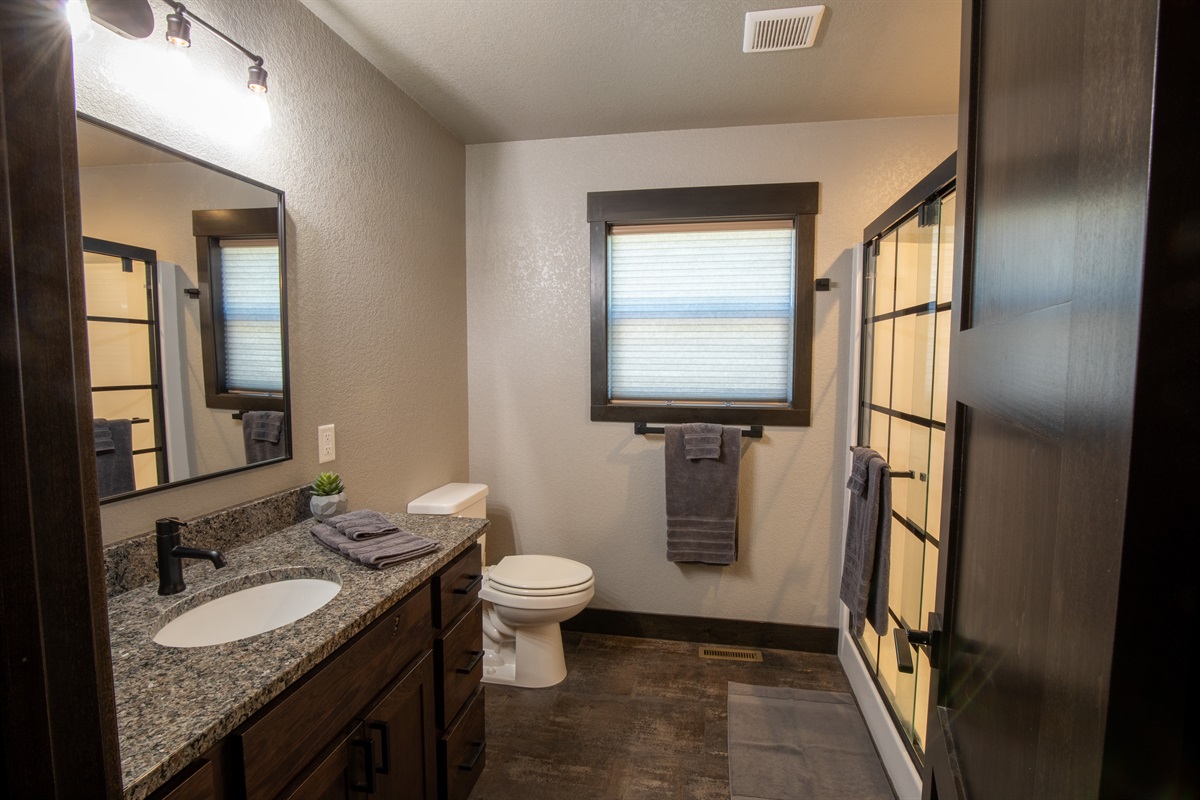 Pamper yourself in the private king ensuite—featuring a spacious granite vanity, soft towels, and a walk-in shower to refresh after a day of exploring. Just steps from the king bed, it's a peaceful and practical retreat.
