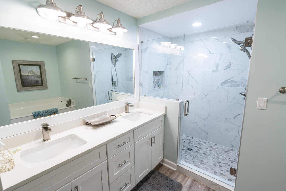 Updated primary bathroom with double vanity and walk-in shower.