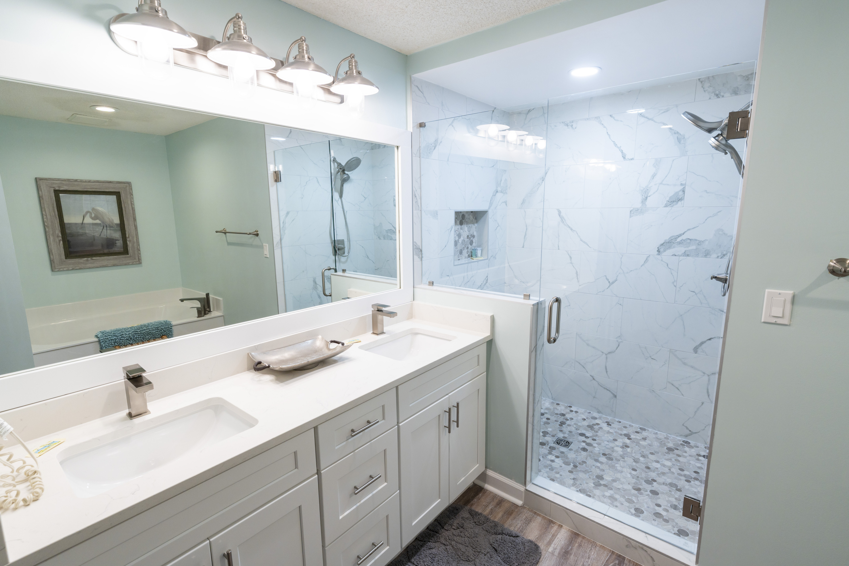 Updated primary bathroom with double vanity and walk-in shower.