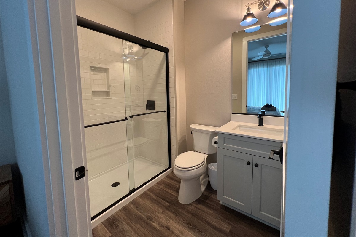 Northwest King bedroom with ensuite and door to deck with hot tub.