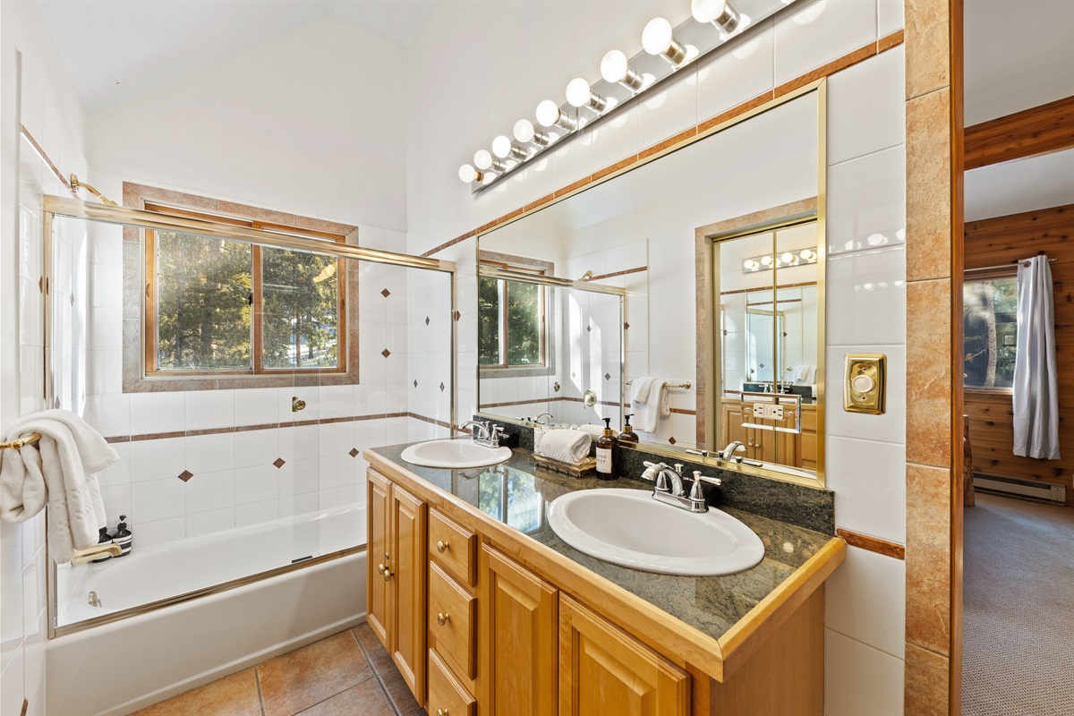 Primary bathroom with dual vanity sinks and TWO showers