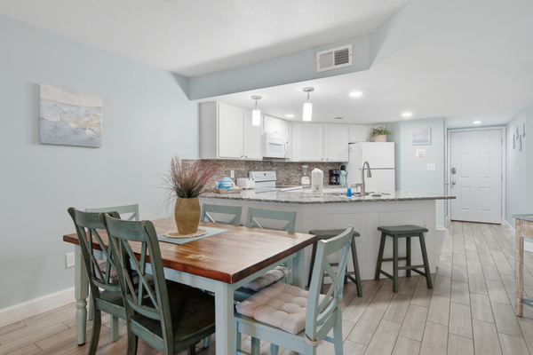 Dining table seats four, open to the kitchen