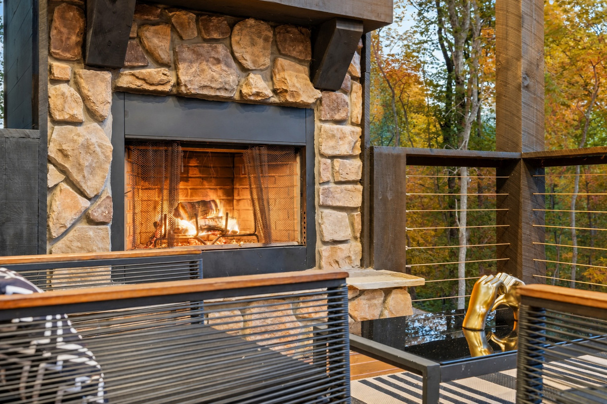 The stone fireplace anchors this outdoor seating area, providing a warm and inviting space to gather and relax.
*Outdoor Fireplace (Available Year Round)