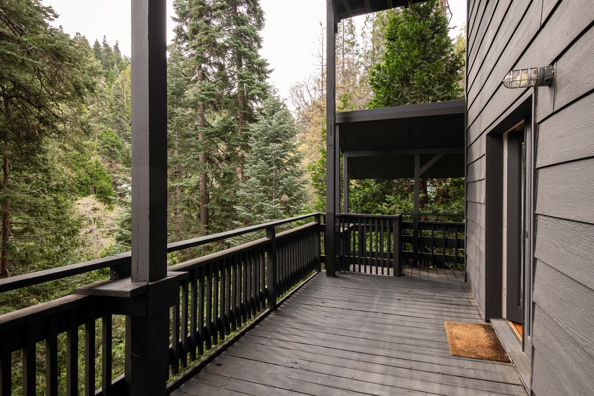 Private deck surrounded by towering trees—perfect for enjoying fresh mountain air and peaceful forest views.