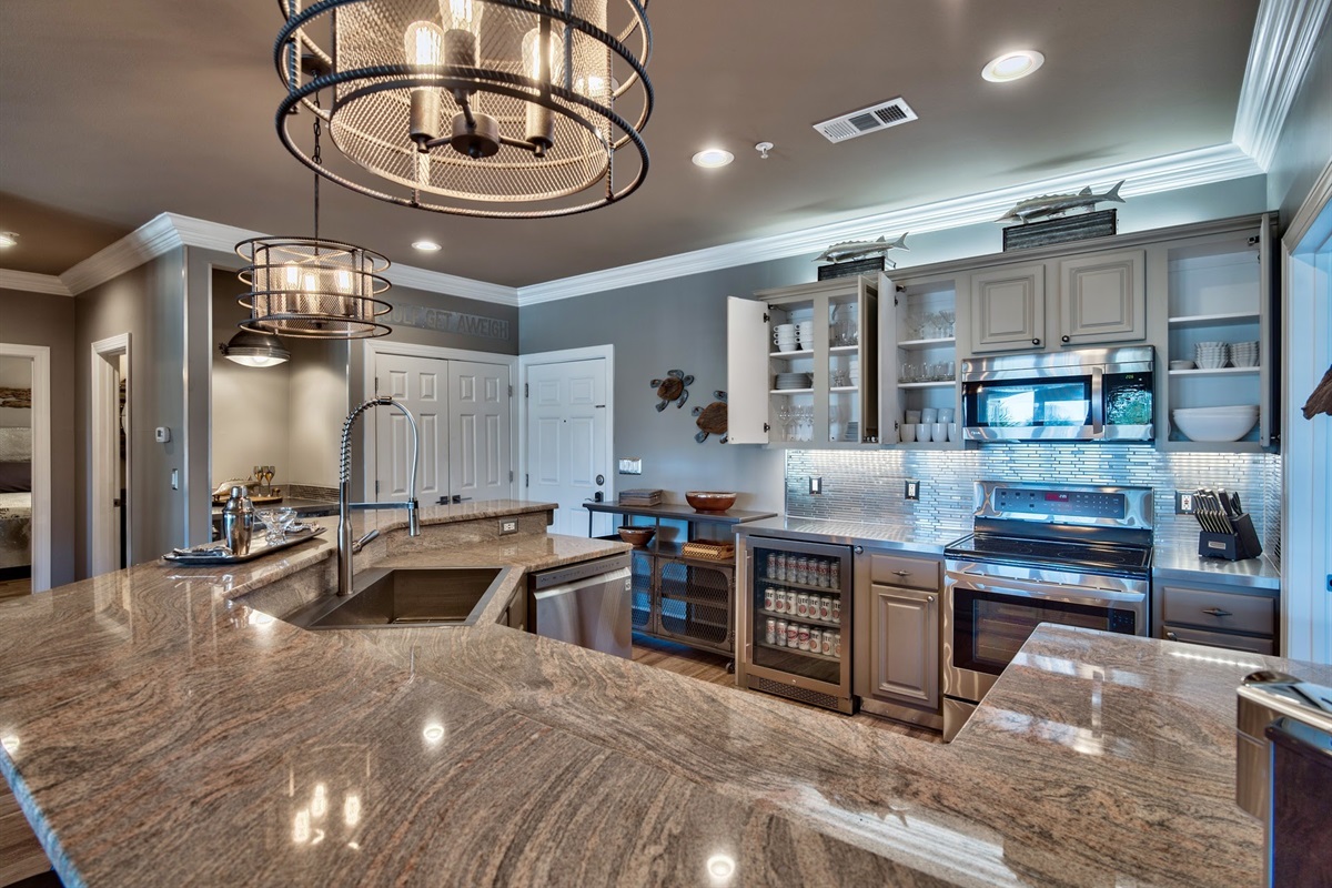 Kitchen with NOLA faucet, zero radius sink and stainless appliances.