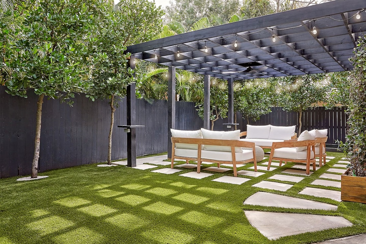 Unwind beneath a custom pergola with comfortable seating, perfectly positioned beside the bocce ball court. A newly installed custom spa adds the perfect touch of luxury and relaxation.