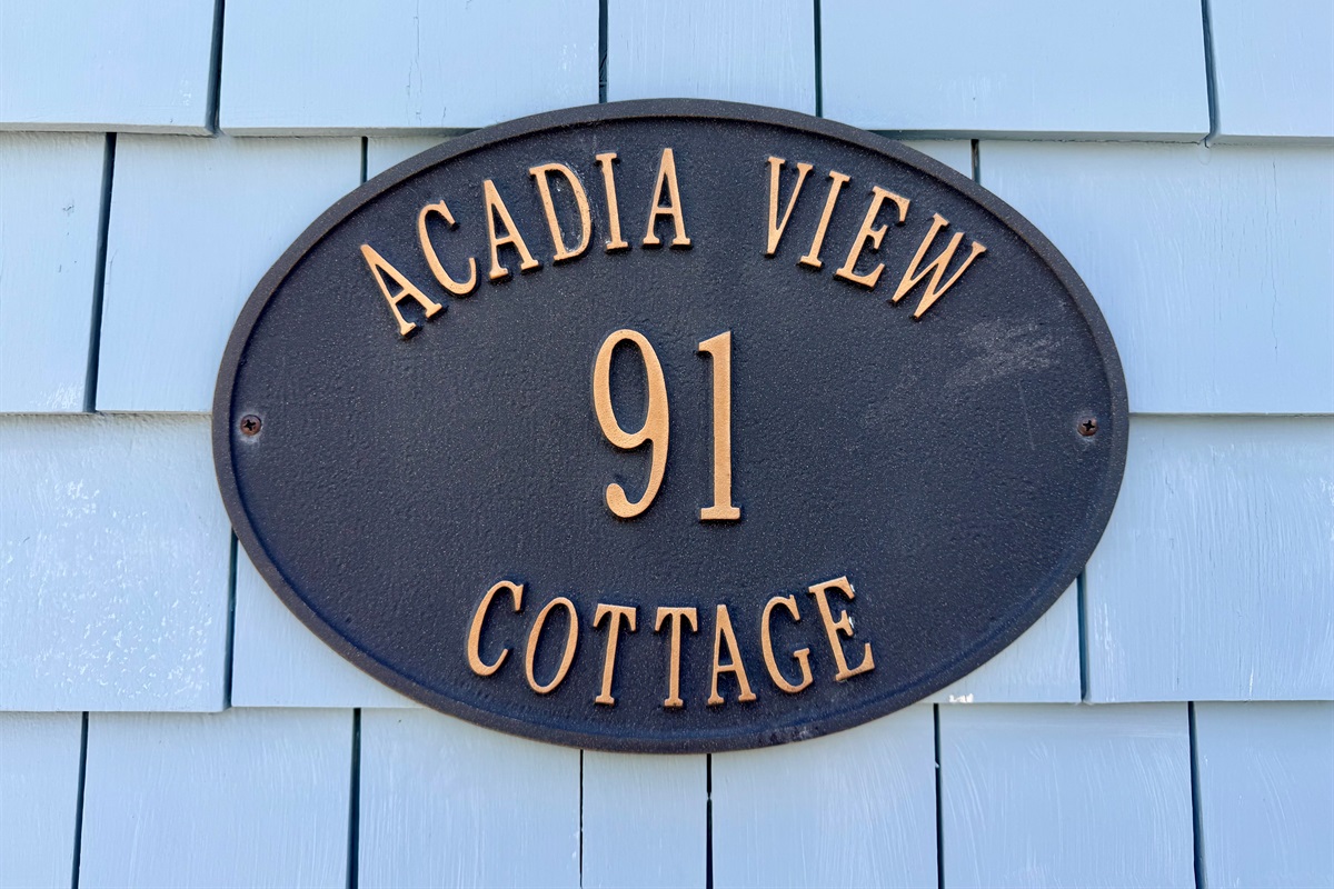 Our name is a geographic fact. This plaque marks the original Acadia View Cottage—a historic Hall Quarry home designed to frame Acadia Mountain perfectly. Unlike generic titles, our "Quiet Side" view is a literal sightline from the upstairs.