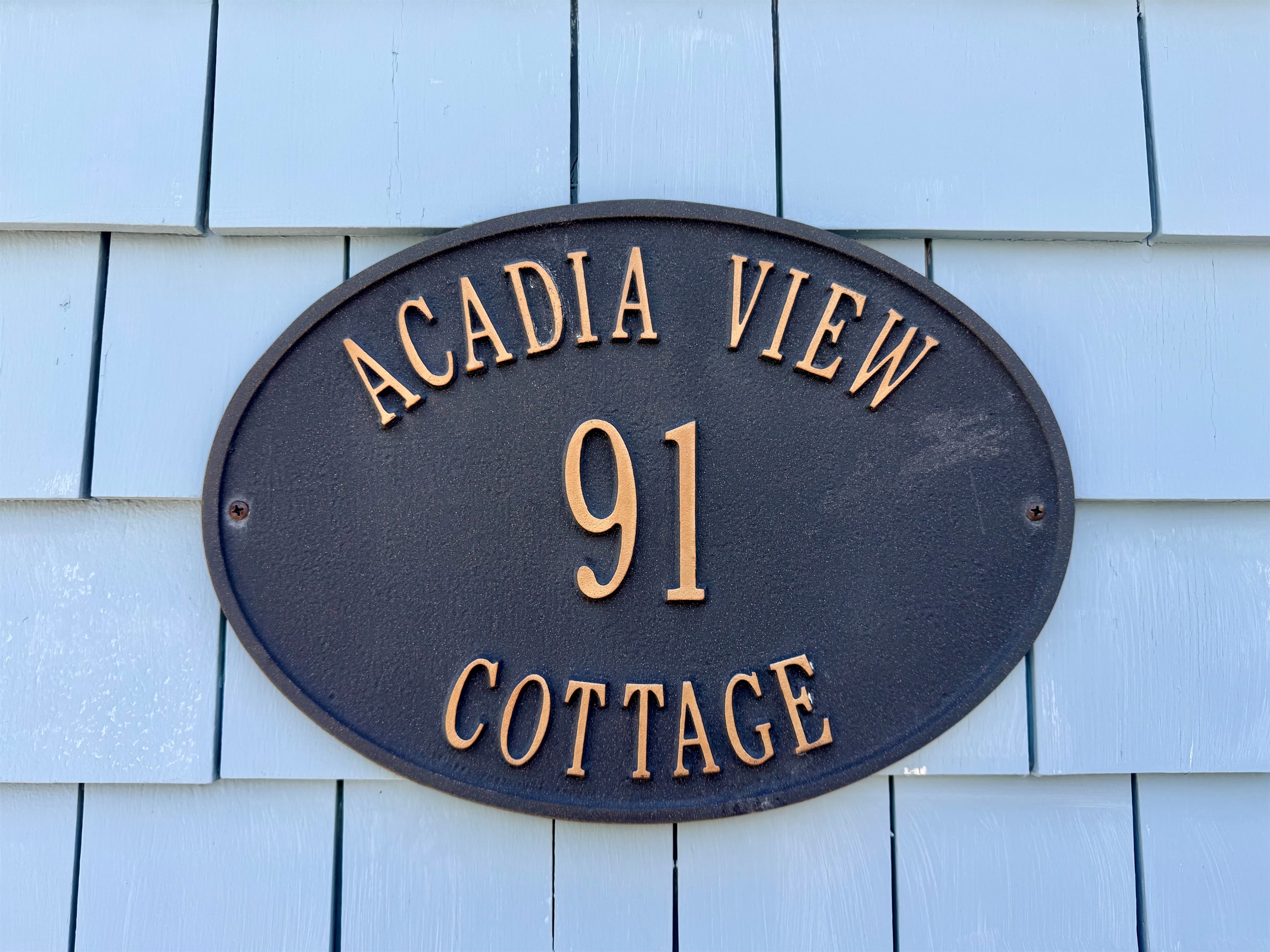 Our name is a geographic fact. This plaque marks the original Acadia View Cottage—a historic Hall Quarry home designed to frame Acadia Mountain perfectly. Unlike generic titles, our "Quiet Side" view is a literal sightline from the upstairs.