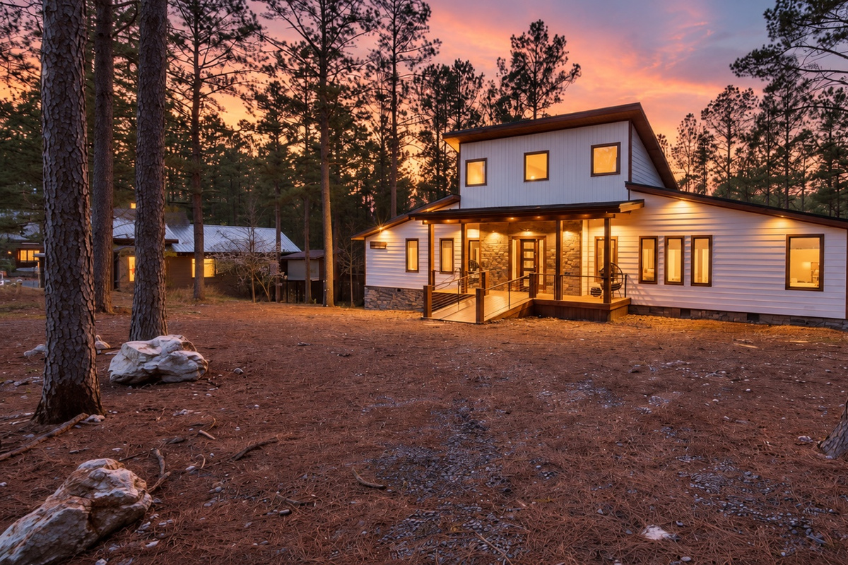 Come home to glowing windows and a sunset painted through the pines.