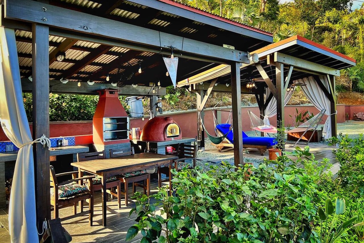 Enjoy shaded seating with cozy chairs and sweeping greenery views.