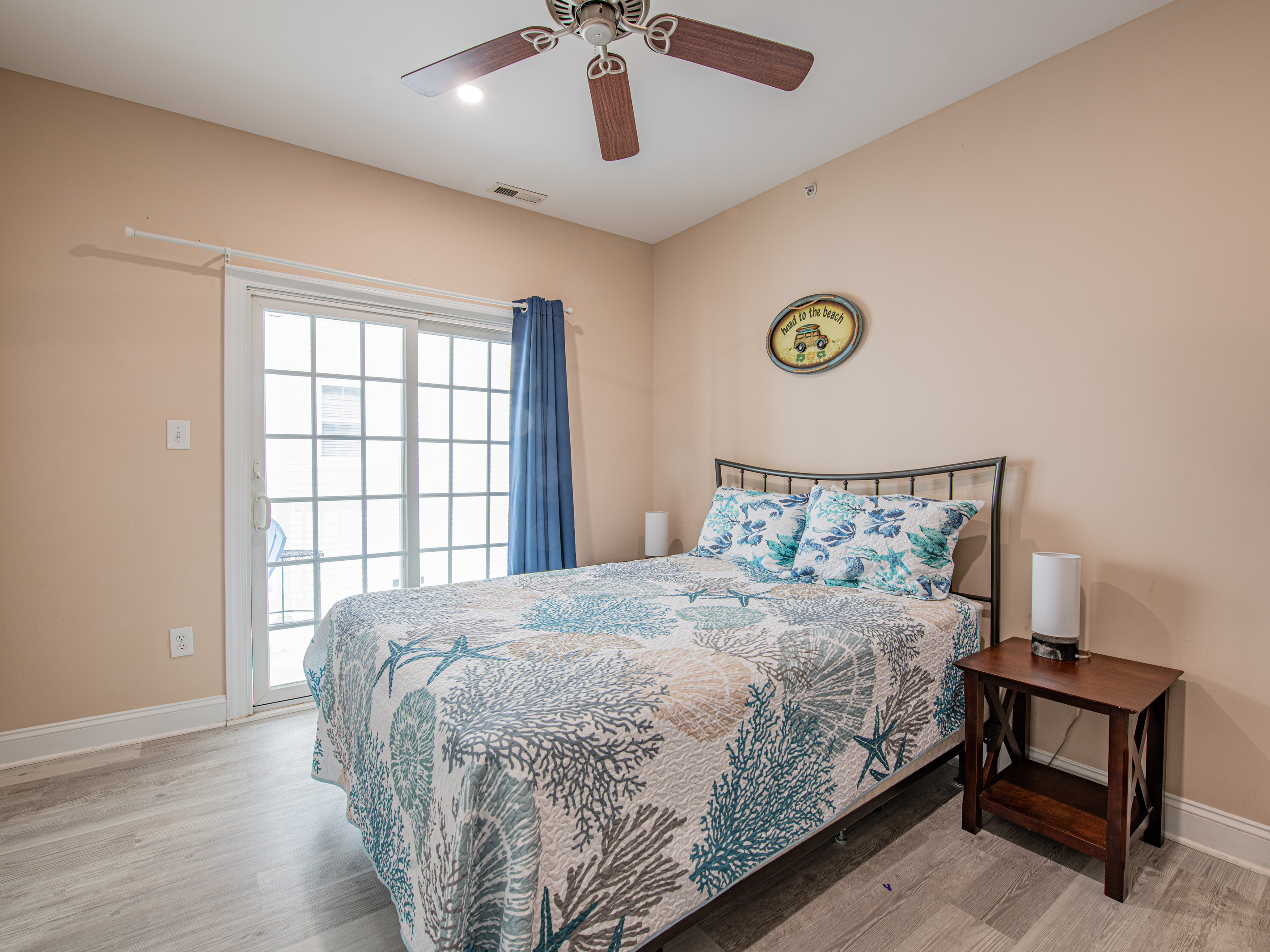Bedroom 6 with Coastal Bedding and Sliding Glass Door Access