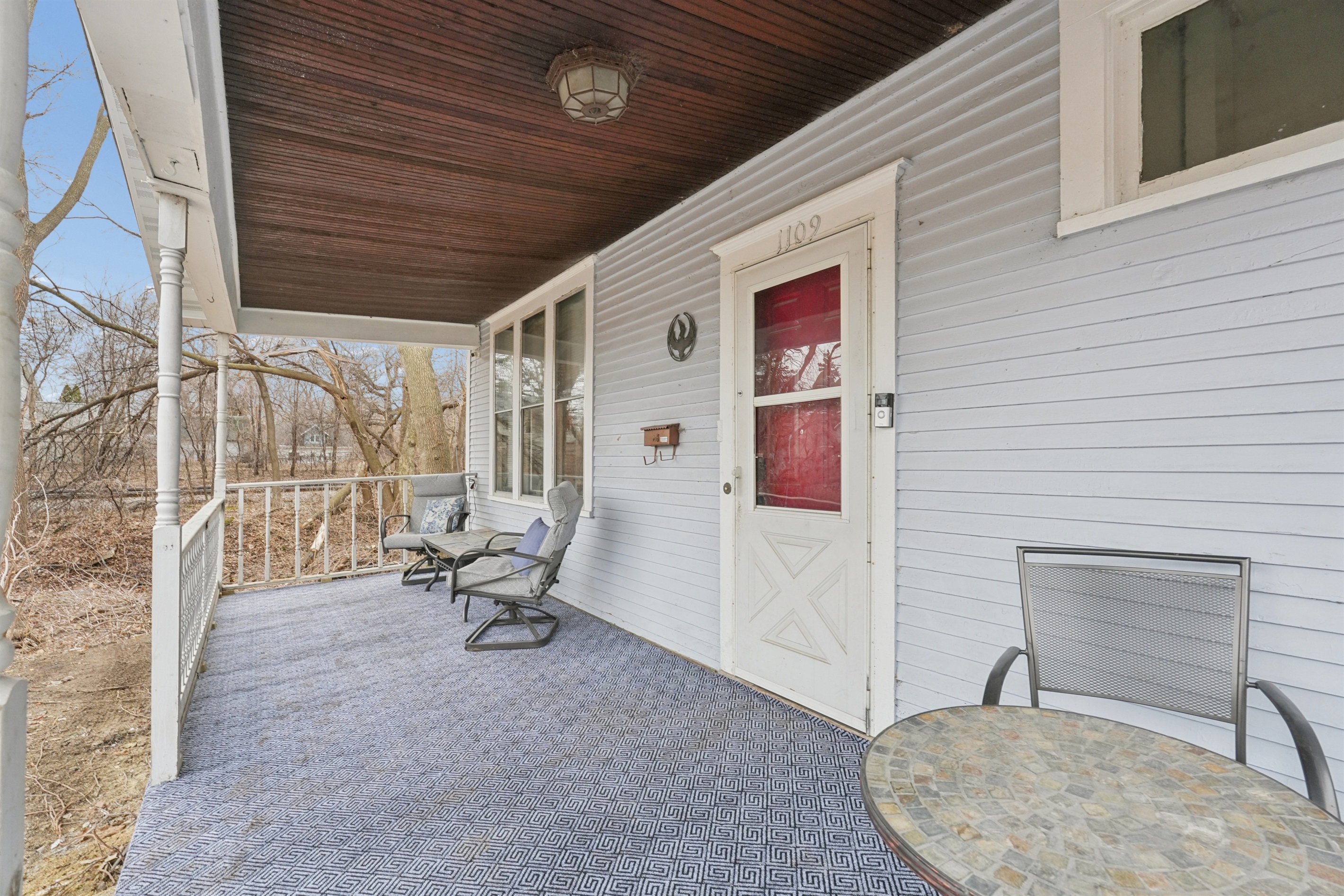 The front porch offers two casual seating nooks for morning coffee, or for watching cute puppies on walks across the cul-de-sac and tiny city park, or watching the nearby trains.