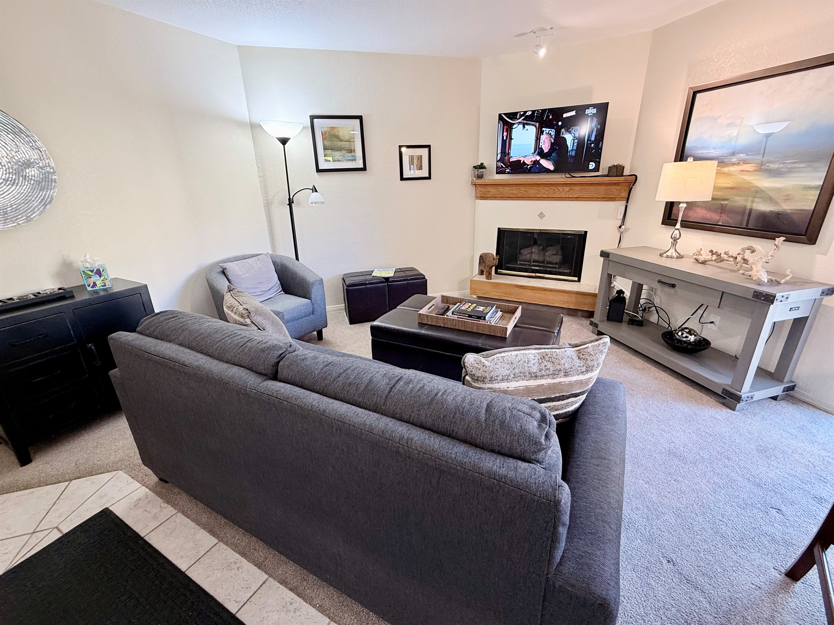 Living Area, with wall mounted smart tv and cable.