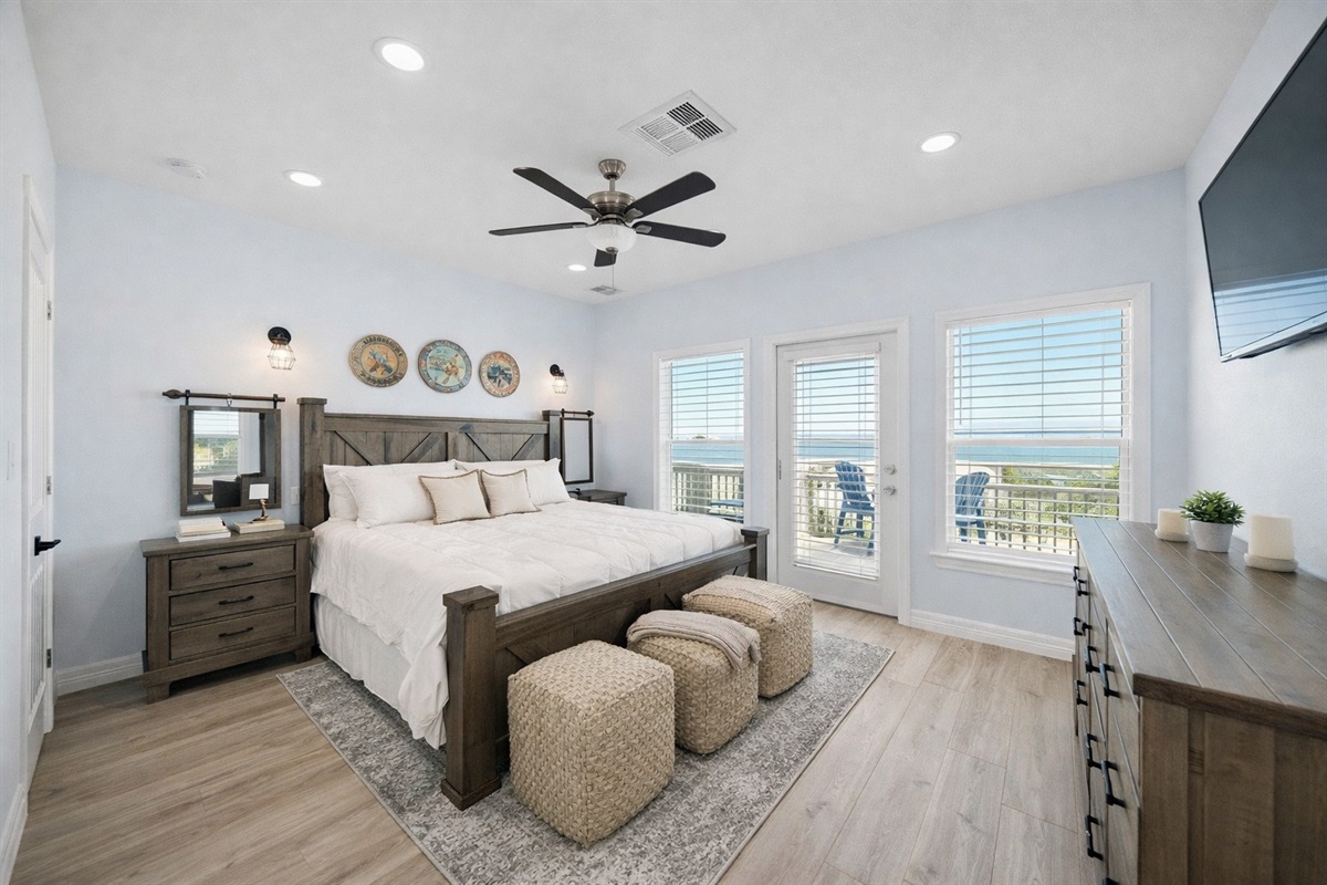 Upstairs King Bedroom (Upper Level – Ensuite): Spacious retreat with deck access and natural light.