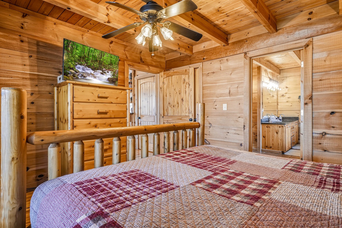 Cozy main level, king bedroom with handcrafted log bed frame, hardwood floors & rustic wildlife wall art in this Great Smoky Mountains cabin rental | Private bedroom, Sleep like a mountain king after a