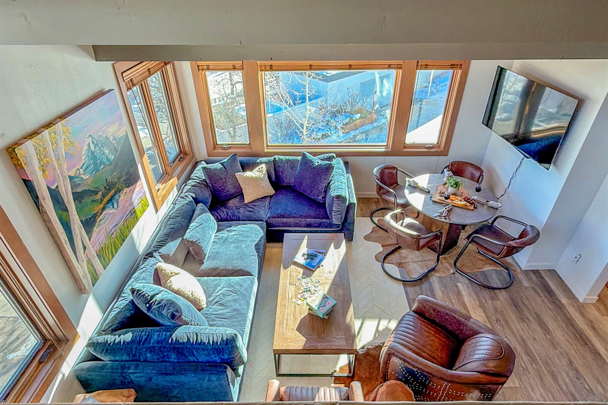 … and a fun vantage point of the TV, cozy living room, & even the views out the large living room windows.