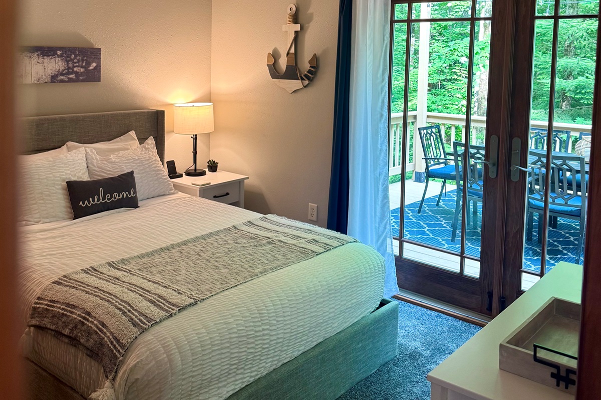 Queen bedroom with walkout French doors to access the back wrap around deck