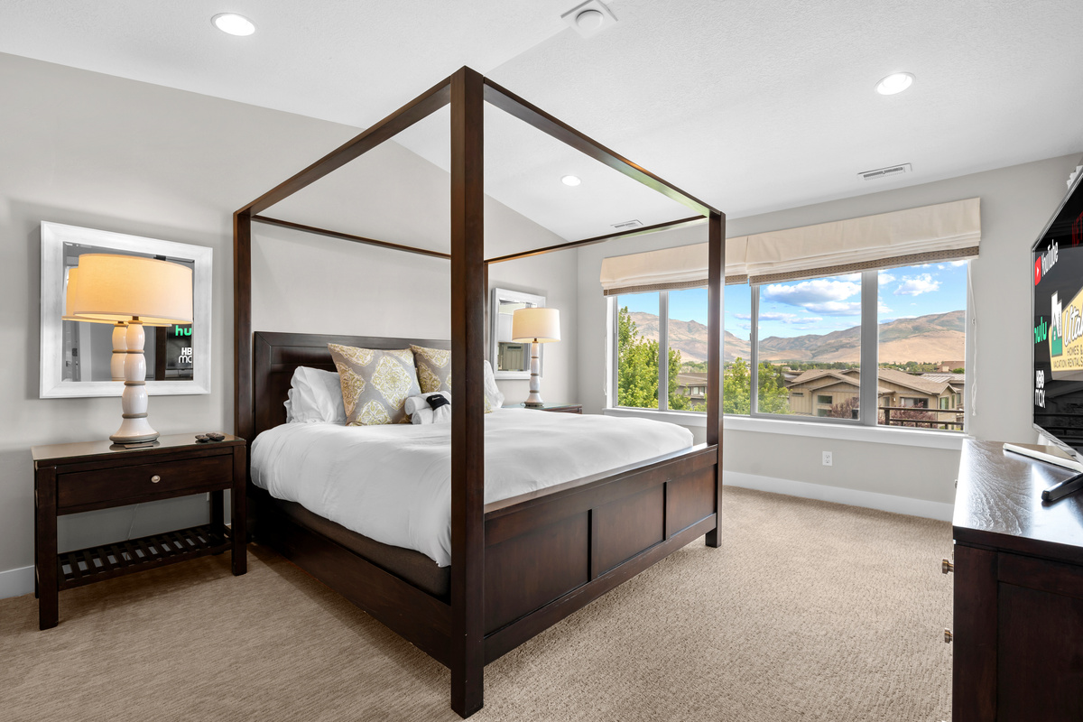 Retreat to the spacious primary suite with a king bed and beautiful mountain views.