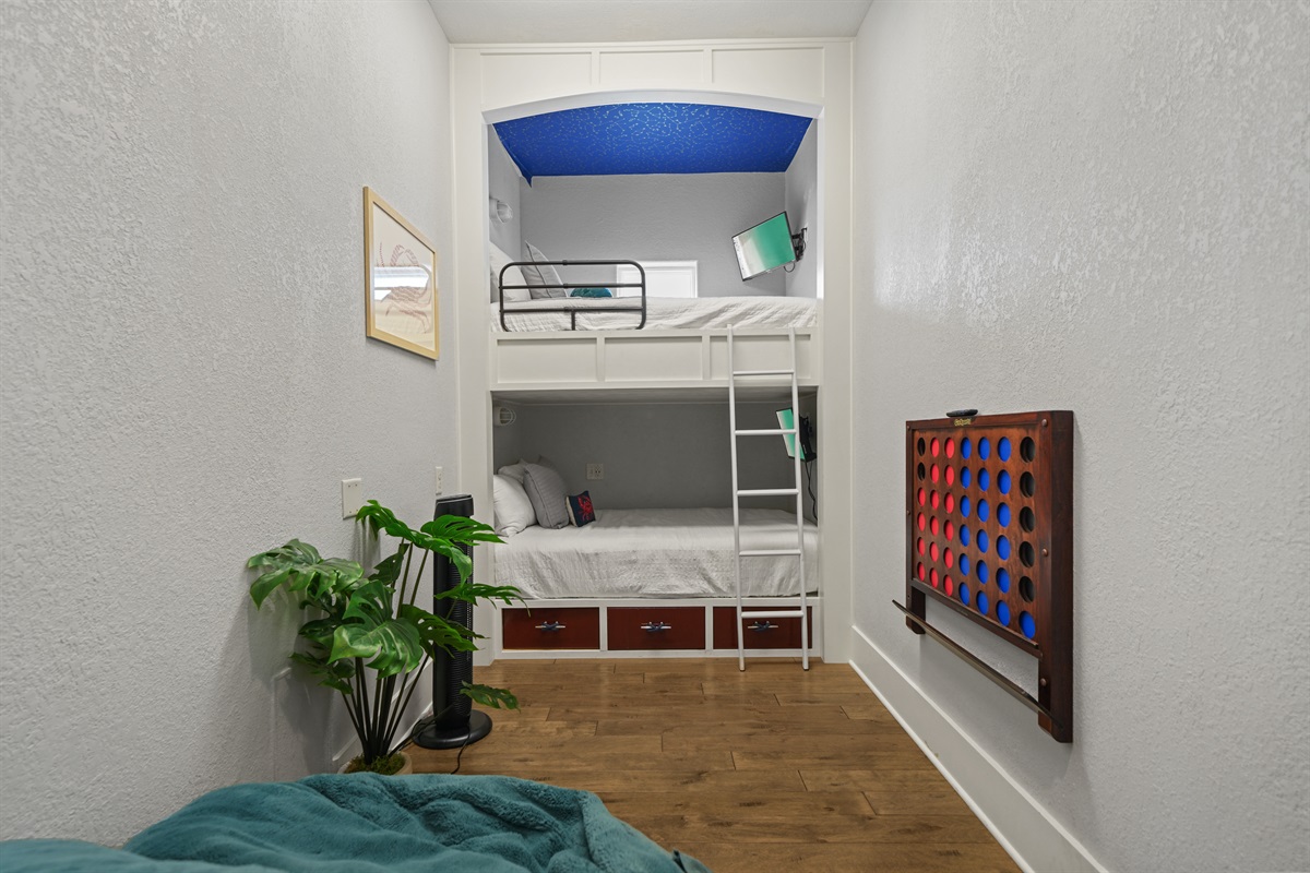 Spacious bunk room with full-over-full beds, games, and fun décor for younger guests.
