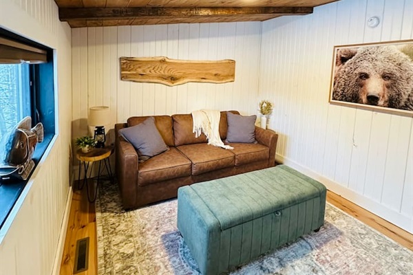 This cozy, open loft features a comfortable queen pullout sofa bed, perfect for two people. The loft overlooks the living room, offering a unique blend of privacy and openness, ideal for those who enjoy a spacious and airy living environment.