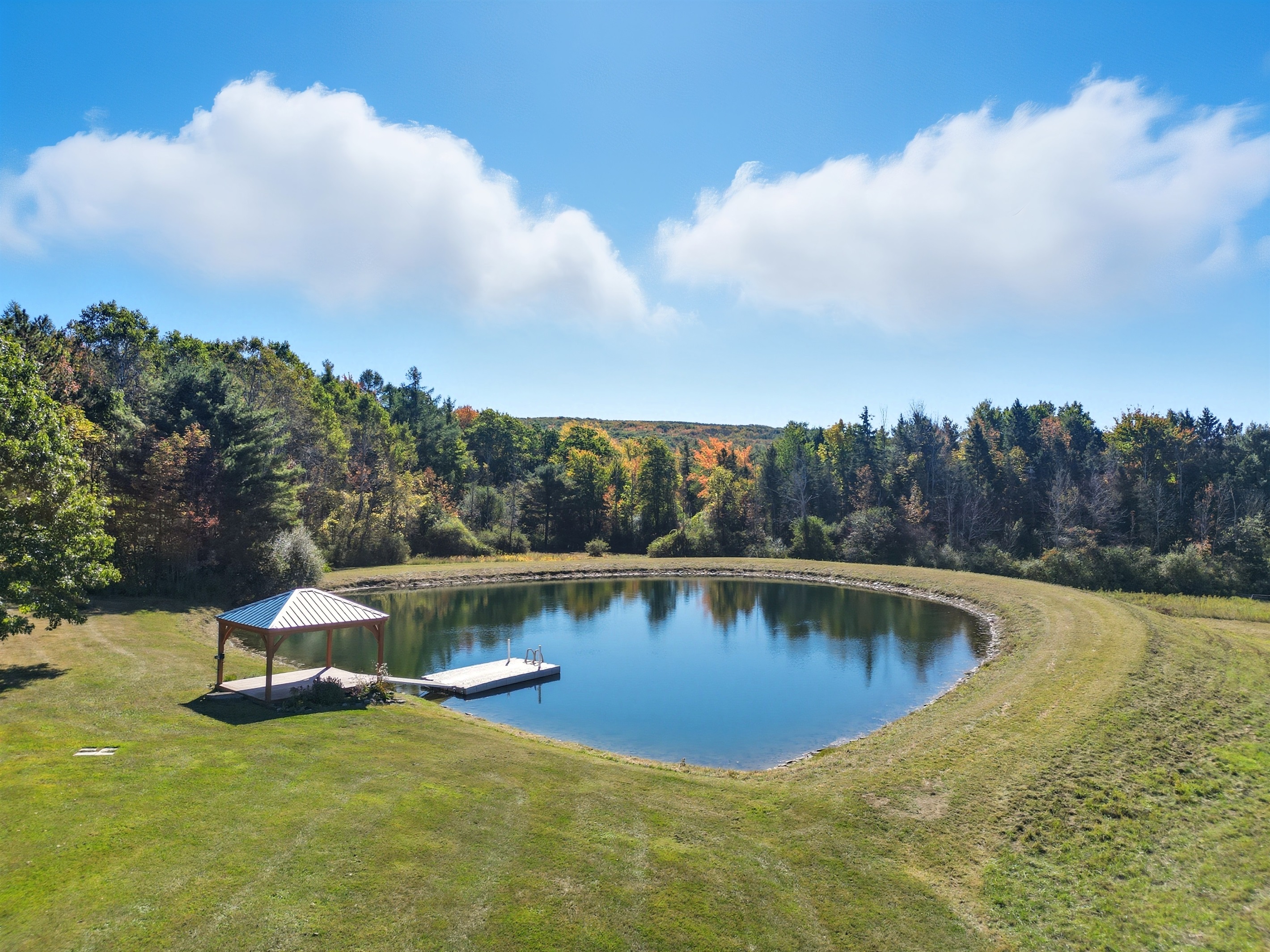 Private pond with seating for relaxing days outdoors.