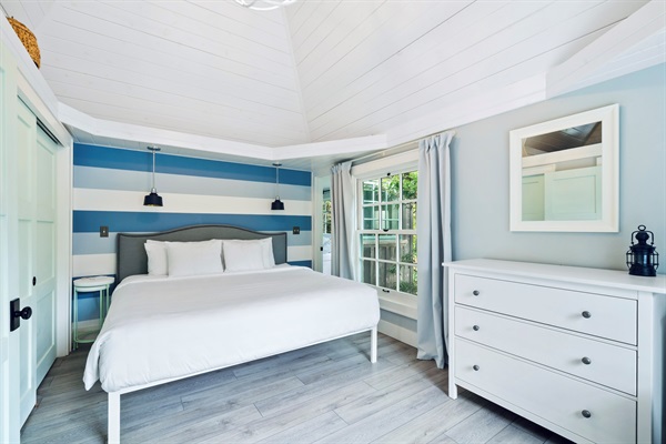 NAUTICAL BEDROOM  corner shows interior access to primary suite through narrow doorway, or there is exterior access - no true hallway