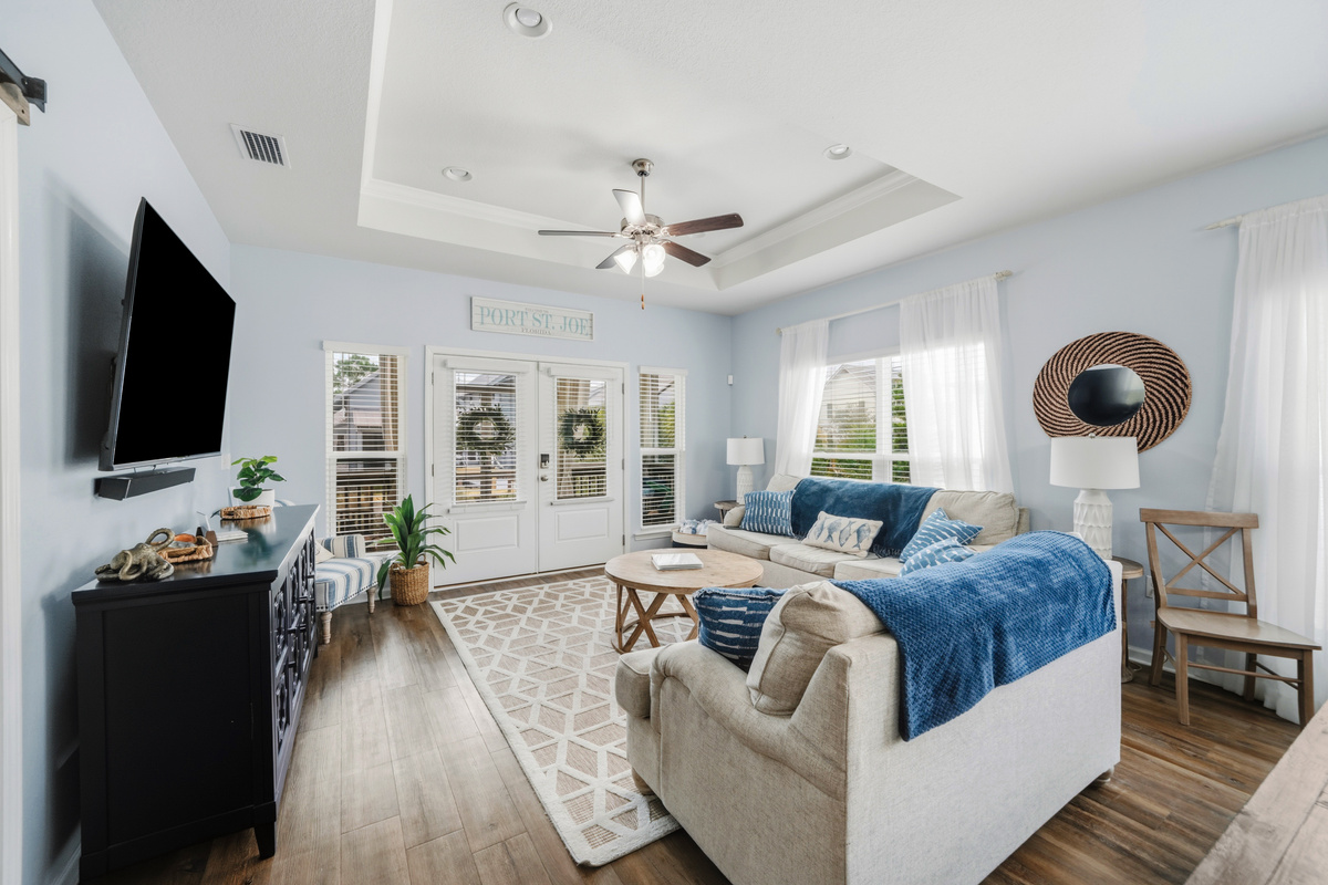 Relax in comfort. Bright and inviting living room with plush seating, perfect for movie nights or gathering with family and friends