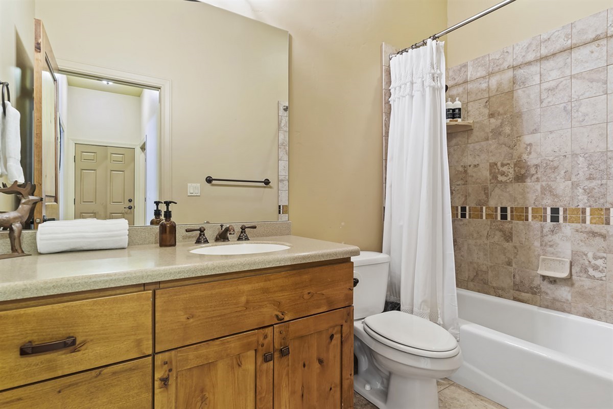 A full bathroom with tub/shower combo and clean, functional design.