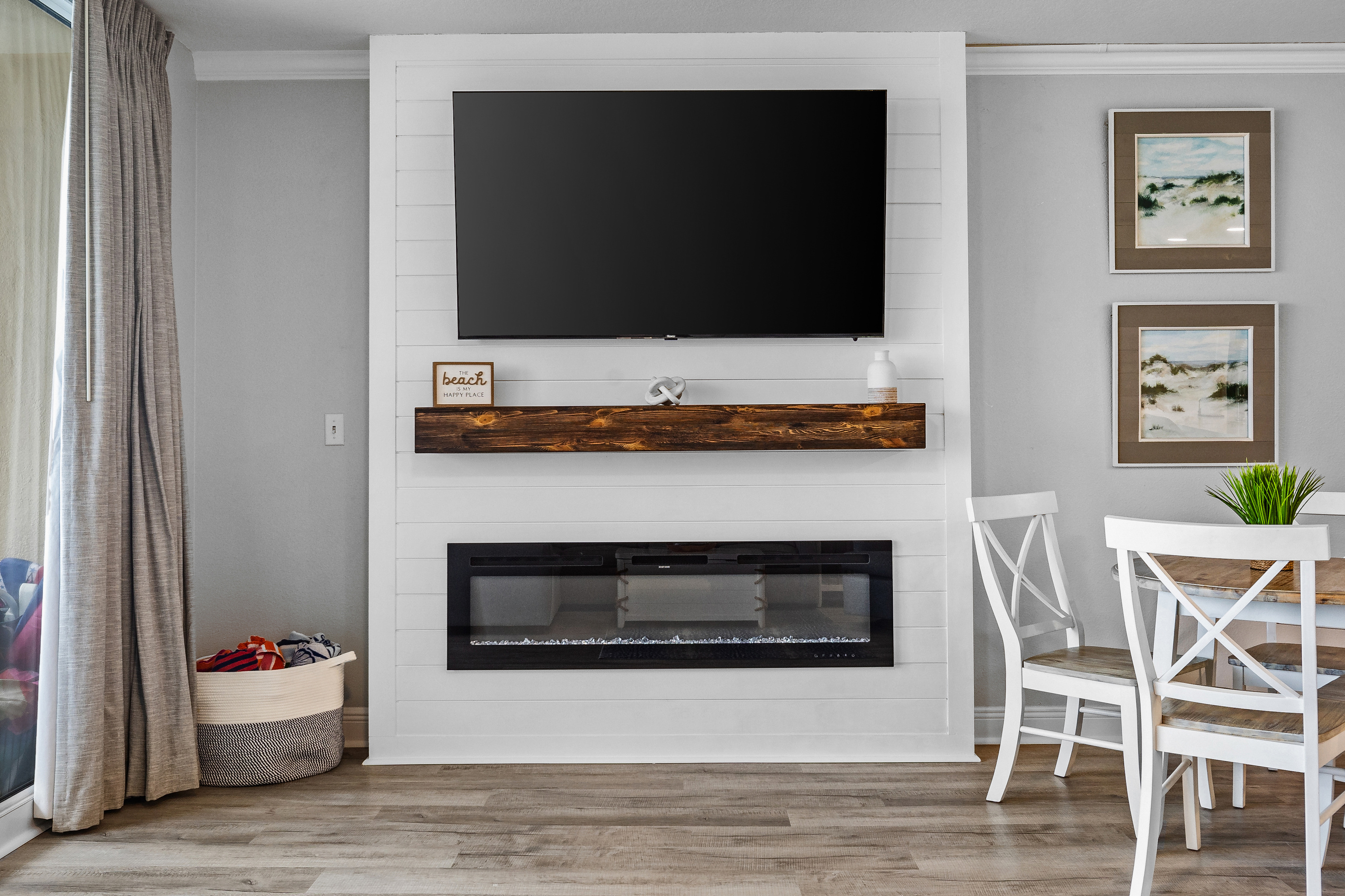 Beach vibes await! Enjoy cozy coastal decor, a smart TV and electric fireplace for relaxing nights in, and a basket stocked with colorful beach towels ready for your next sun-soaked adventure.