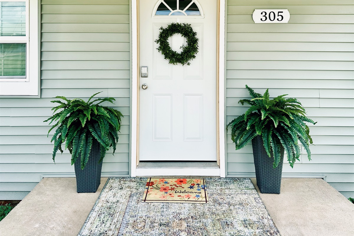 Fresh porch plants and rug - welcome!