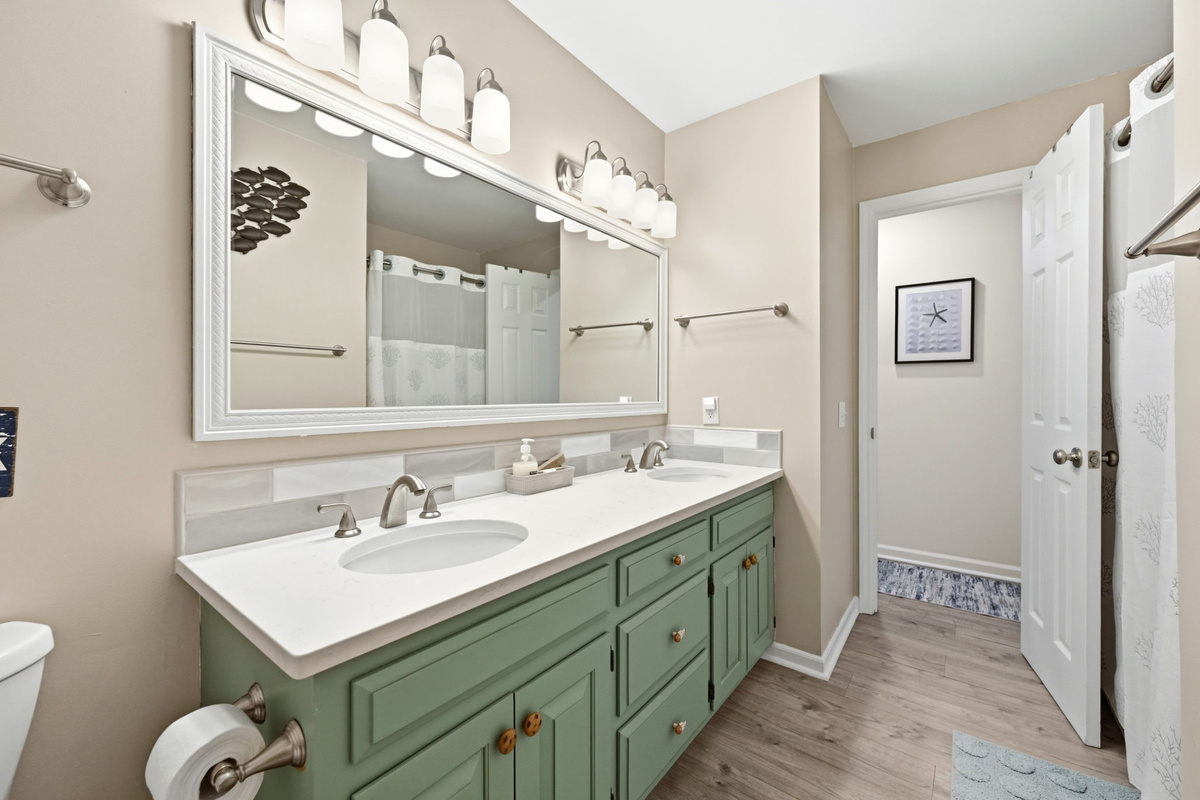 A convenient full bathroom located just steps from the guest bedroom.