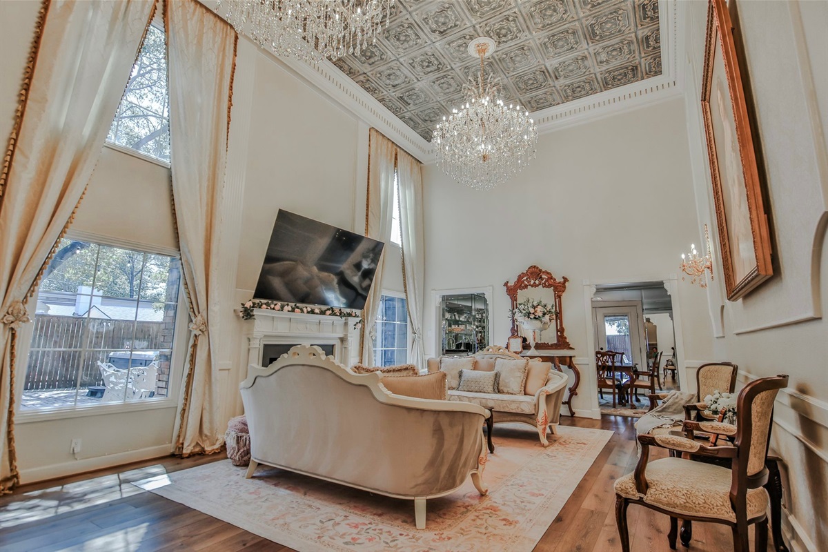 A room made for long conversations, soft laughter, and perhaps a whispered secret beneath the chandeliers.