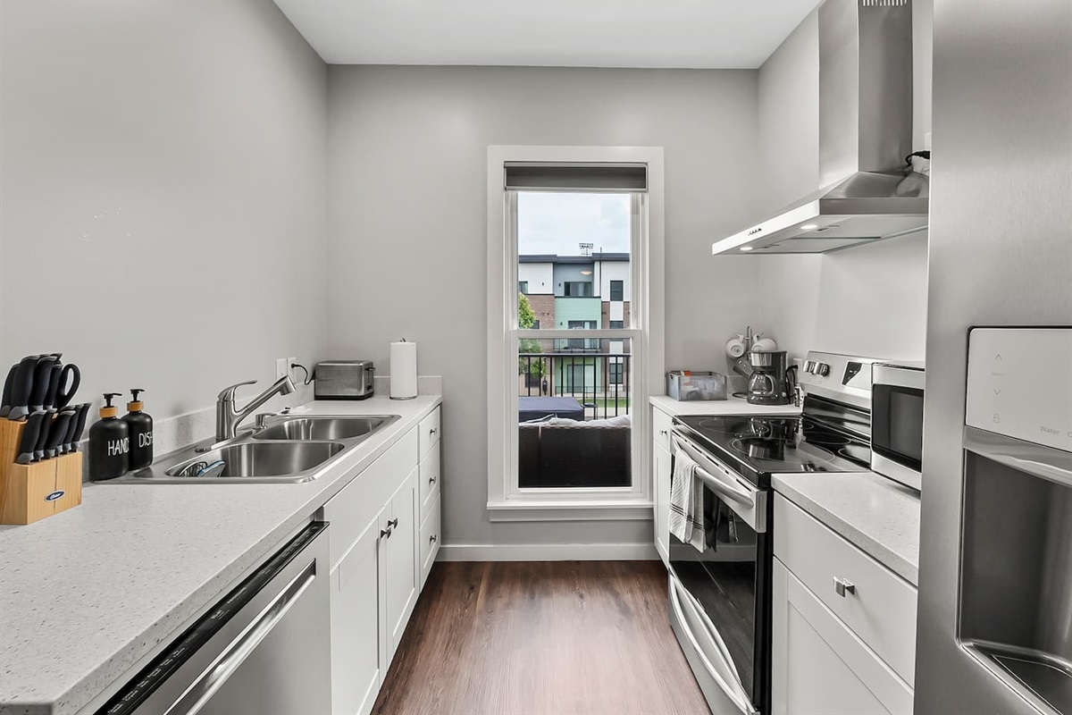 Large window bringing in natural light, creating a bright and welcoming cooking space.