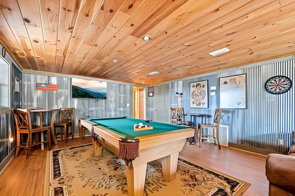 The ultimate indoor hangout space. This spacious game room comes fully equipped with a classic pool table, dartboard, high-top seating, and a TV—perfect for rainy days or evening entertainment.