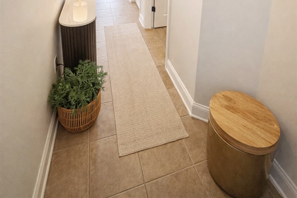 Entryway to the unit with warm and inviting decor