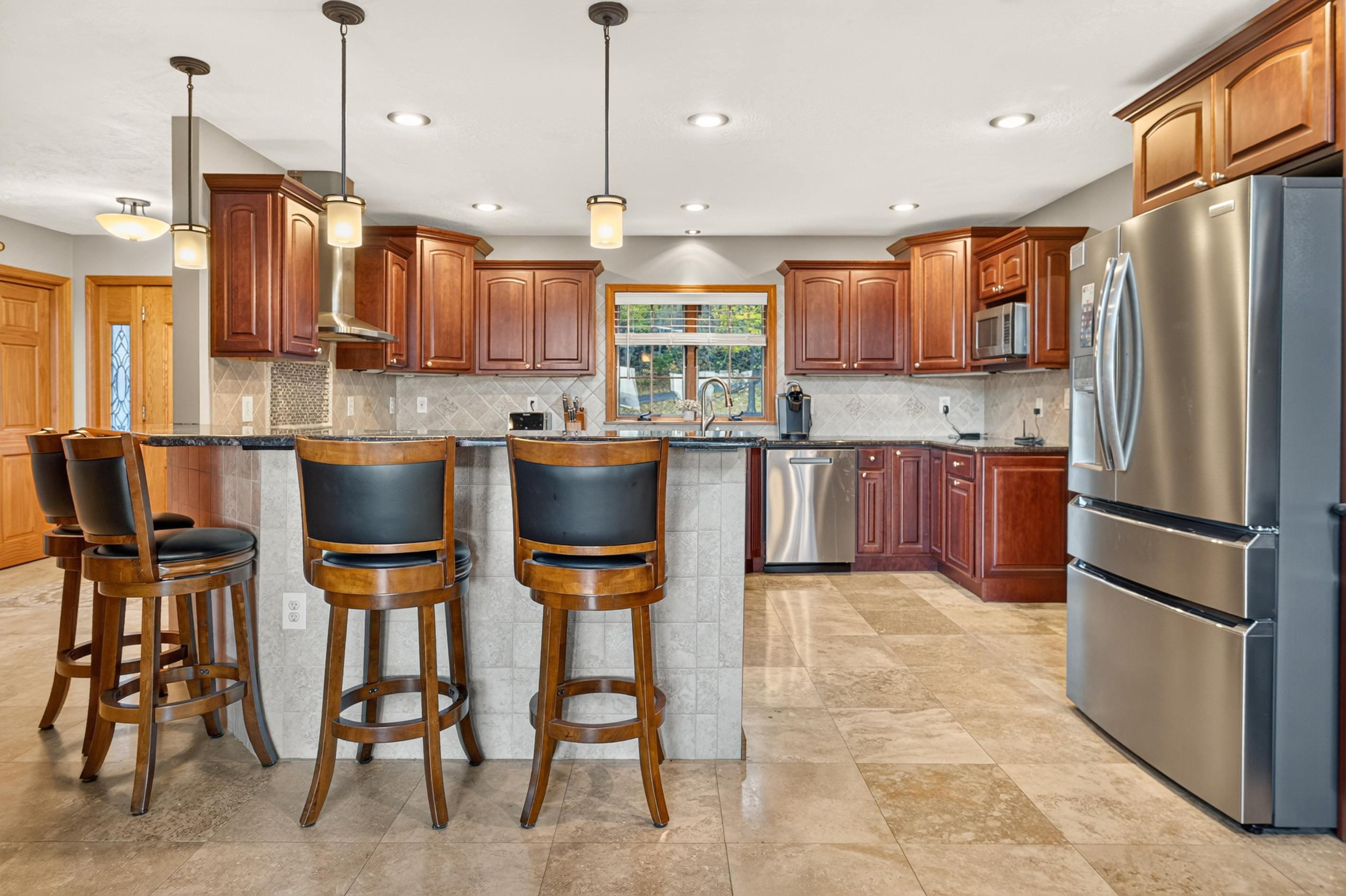 Kitchen with breakfast bar and pendant lighting