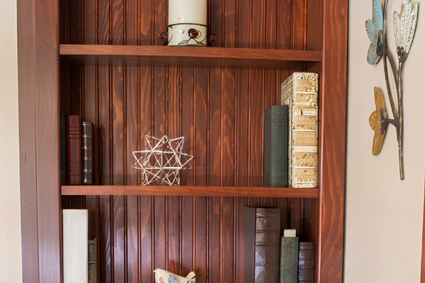 This bookcase holds a few trinkets and a secret door too!