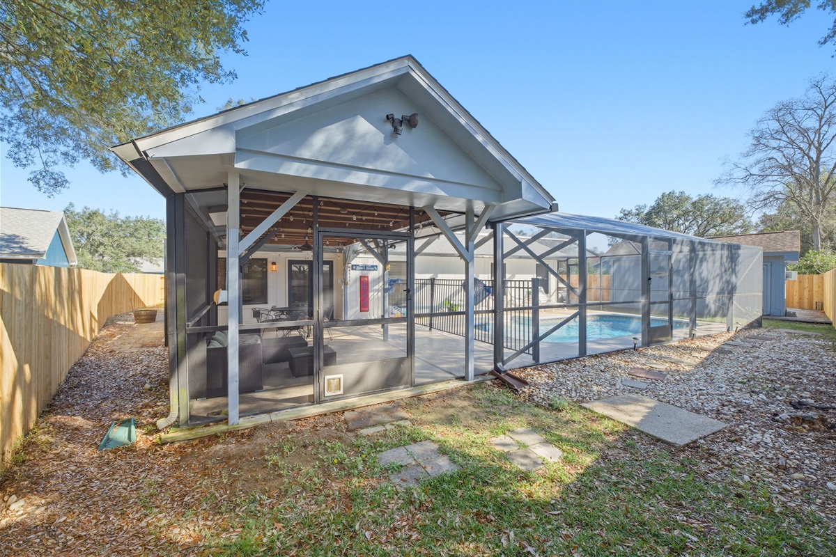 The backyard features a spacious screened patio that flows seamlessly into the pool area, creating the perfect space for gatherings or quiet evenings outdoors. With plenty of seating and shade, it’s an ideal setting for enjoying Florida living year-round.