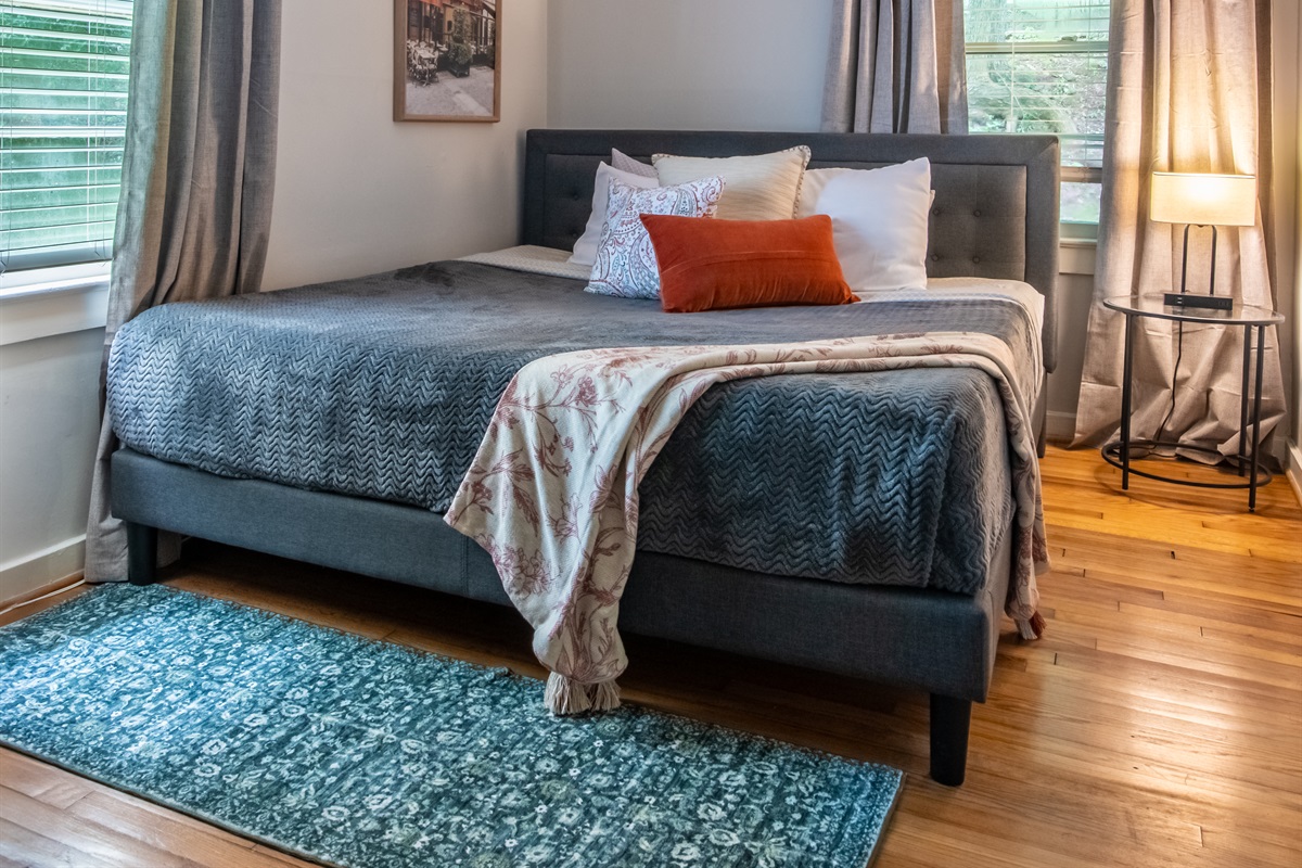 Stylish master bedroom featuring a luxurious bed and modern furniture accents.