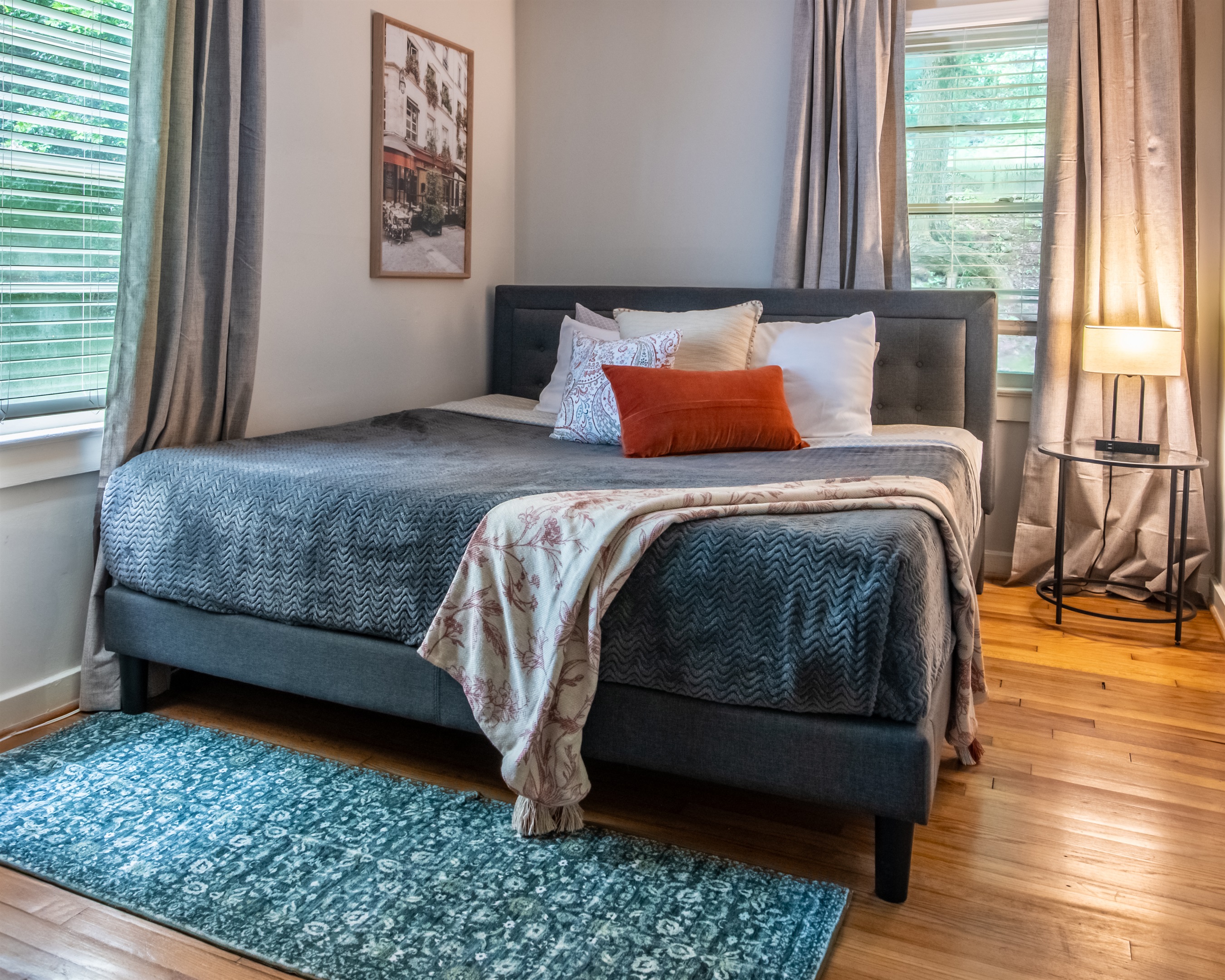 Stylish master bedroom featuring a luxurious bed and modern furniture accents.