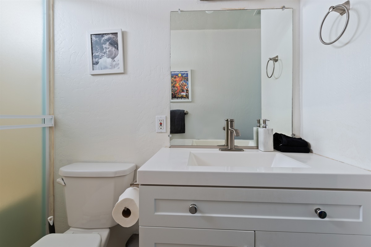 Clean bathroom with modern vanity and storage