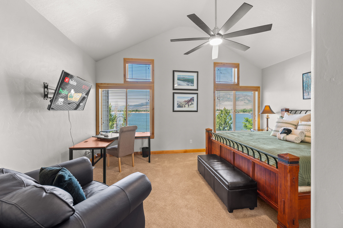 Spacious primary suite featuring a king bed, Smart TV, and reservoir views.