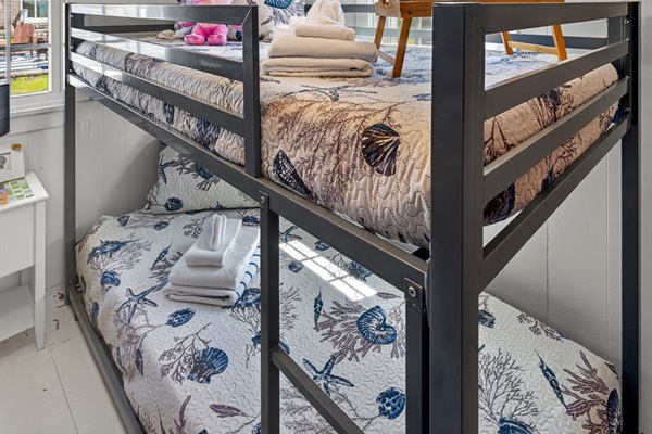 Bright and welcoming, this bunk room is designed for fun, comfort, and restful nights.