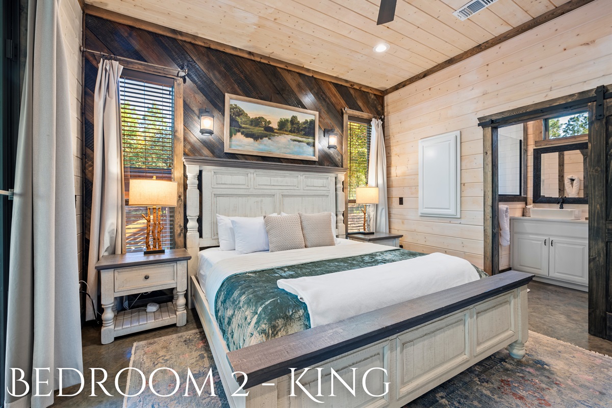 This charming king bedroom provides the perfect retreat, offering a cozy atmosphere and views of the surrounding trees.