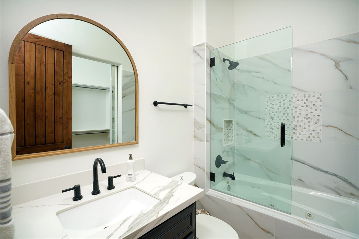 Another ensuite bathroom with shower / jetted tub combo.