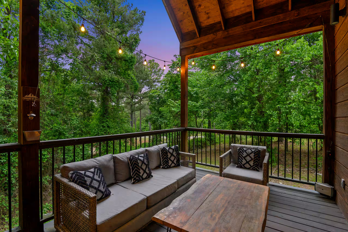 Outdoor Lounge: Relax under string lights on the porch amidst lush greenery and tranquil views!