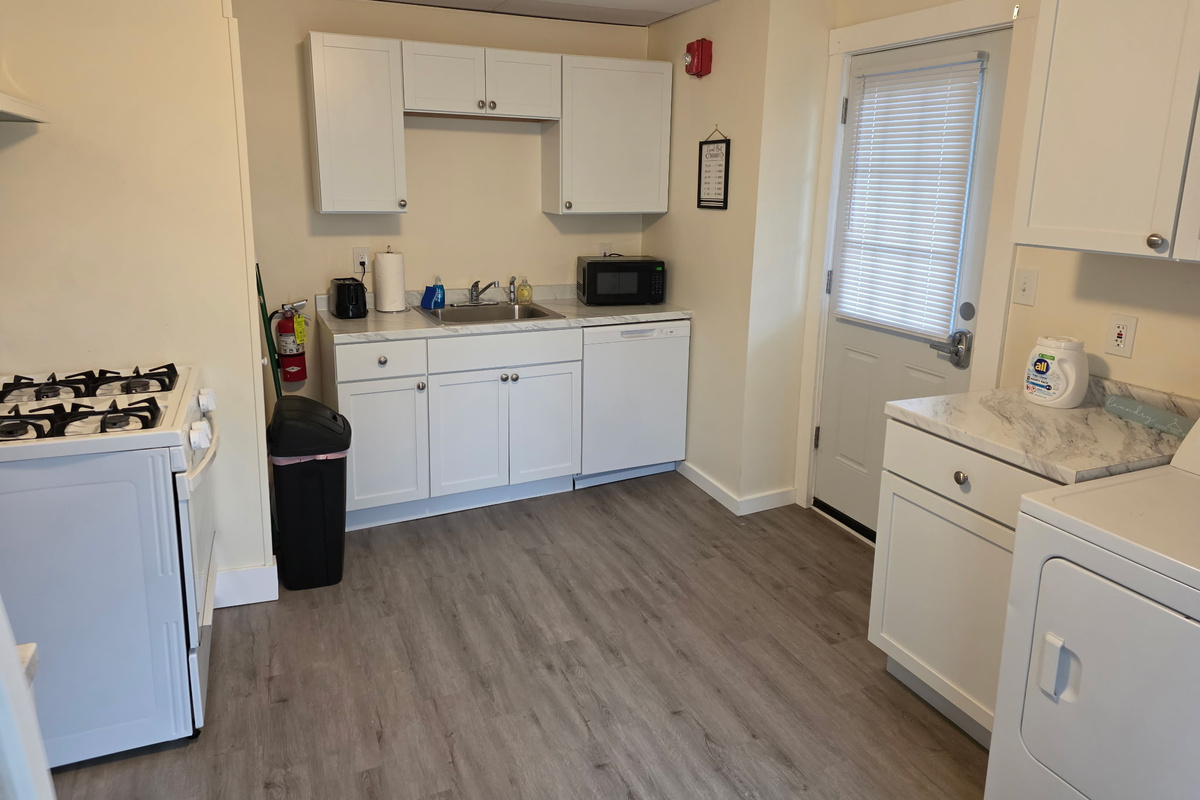 Kitchen with dishwasher and door to covered back porch