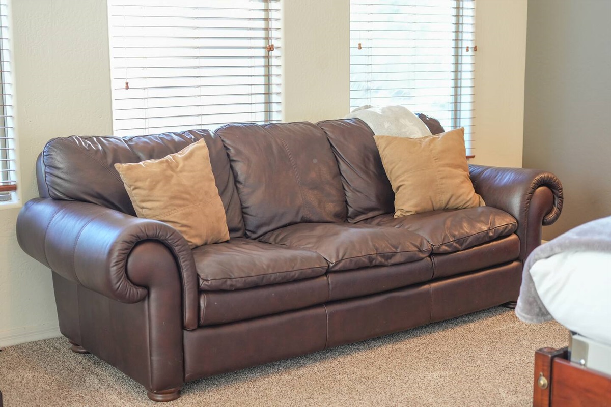 Comfortable sofa seating inside the primary bedroom for added relaxation